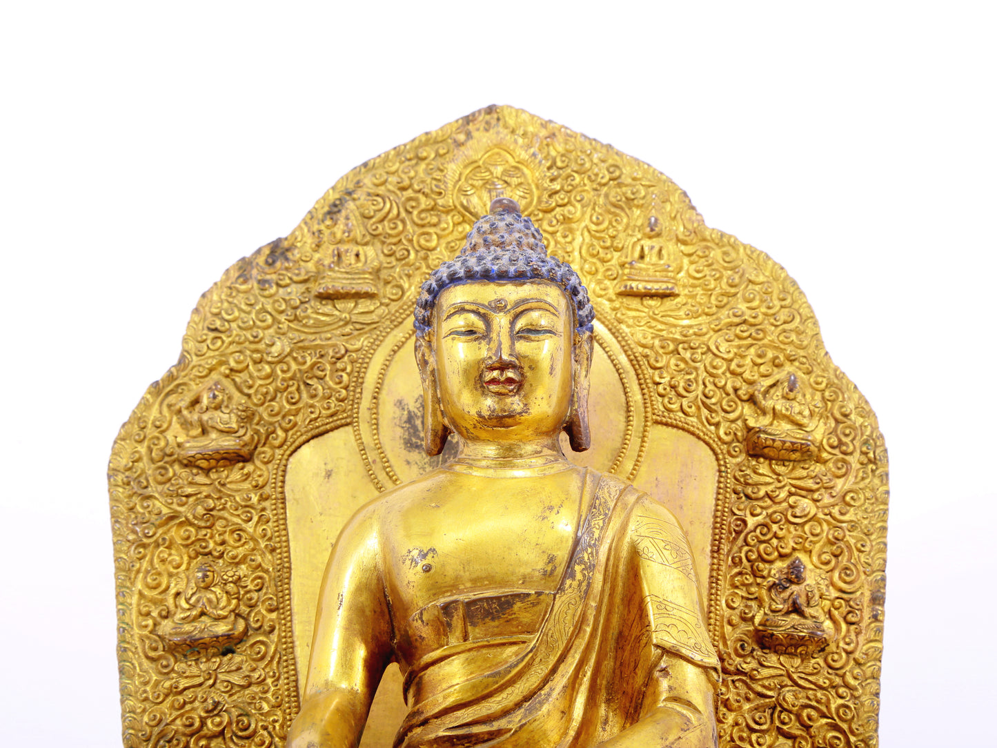 A solemn gilt bronze statue of Gautama Buddha