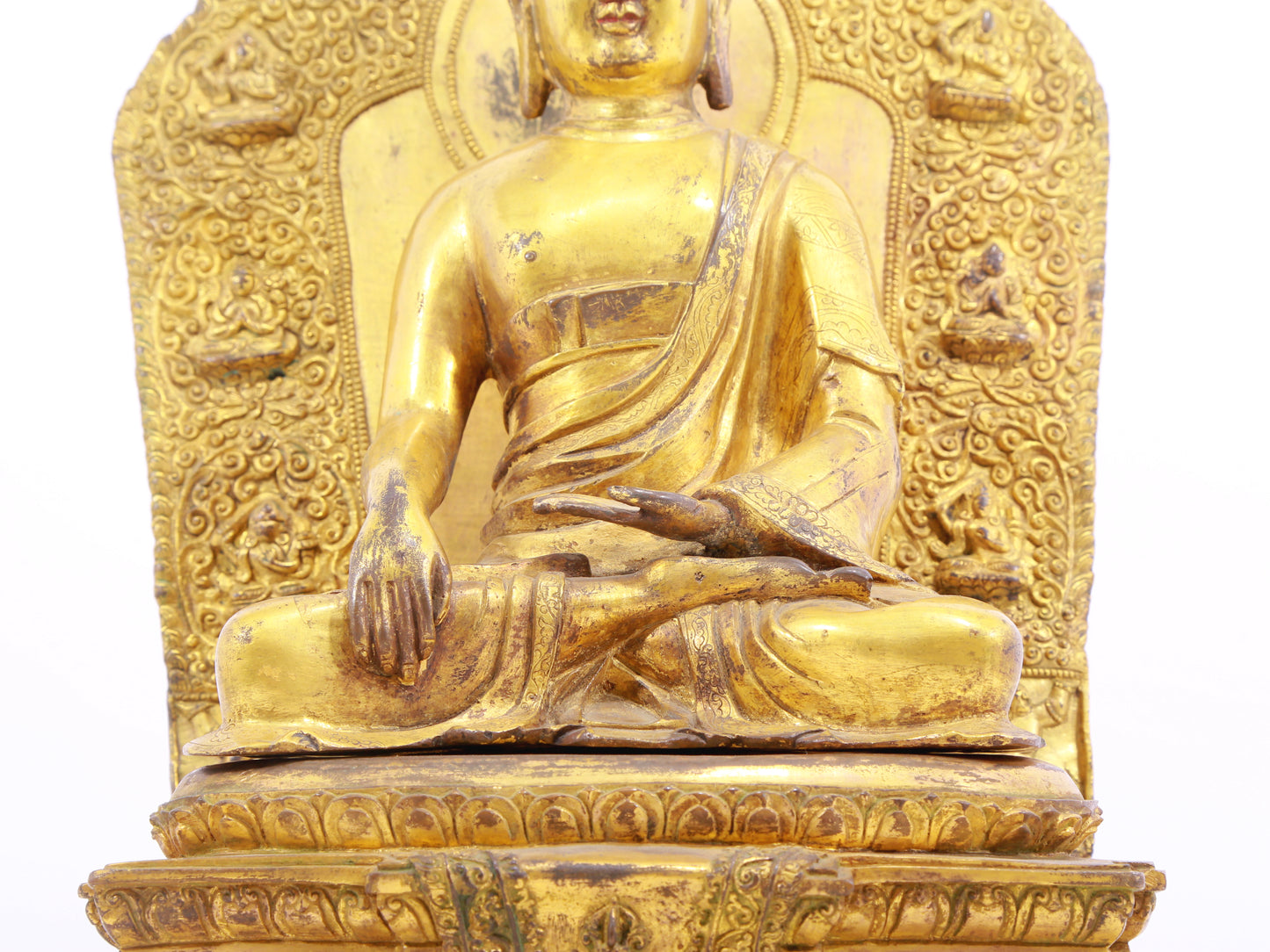 A solemn gilt bronze statue of Gautama Buddha