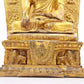 A solemn gilt bronze statue of Gautama Buddha