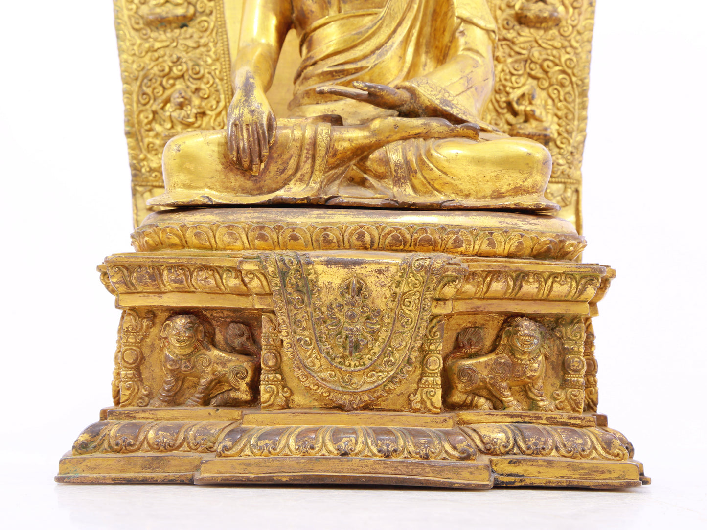 A solemn gilt bronze statue of Gautama Buddha