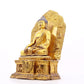 A solemn gilt bronze statue of Gautama Buddha