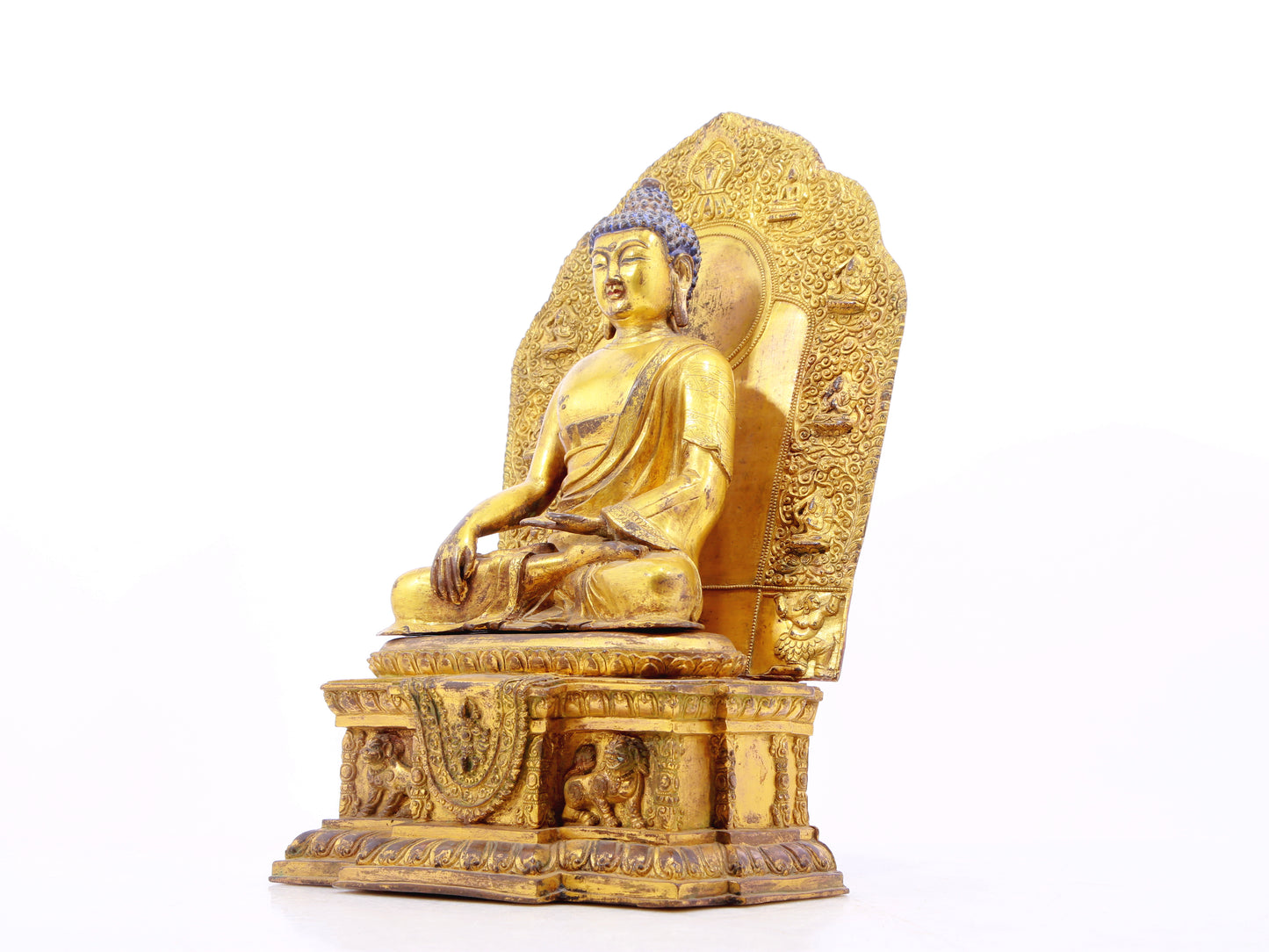 A solemn gilt bronze statue of Gautama Buddha