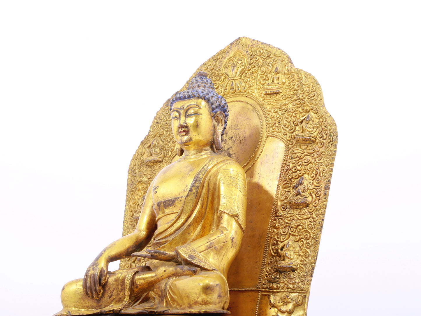 A solemn gilt bronze statue of Gautama Buddha