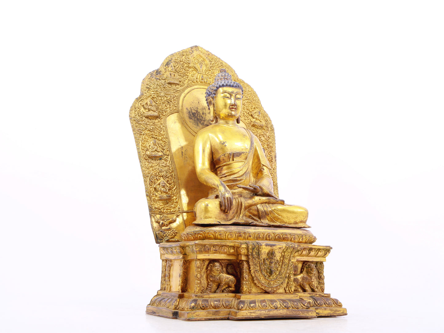 A solemn gilt bronze statue of Gautama Buddha