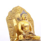 A solemn gilt bronze statue of Gautama Buddha