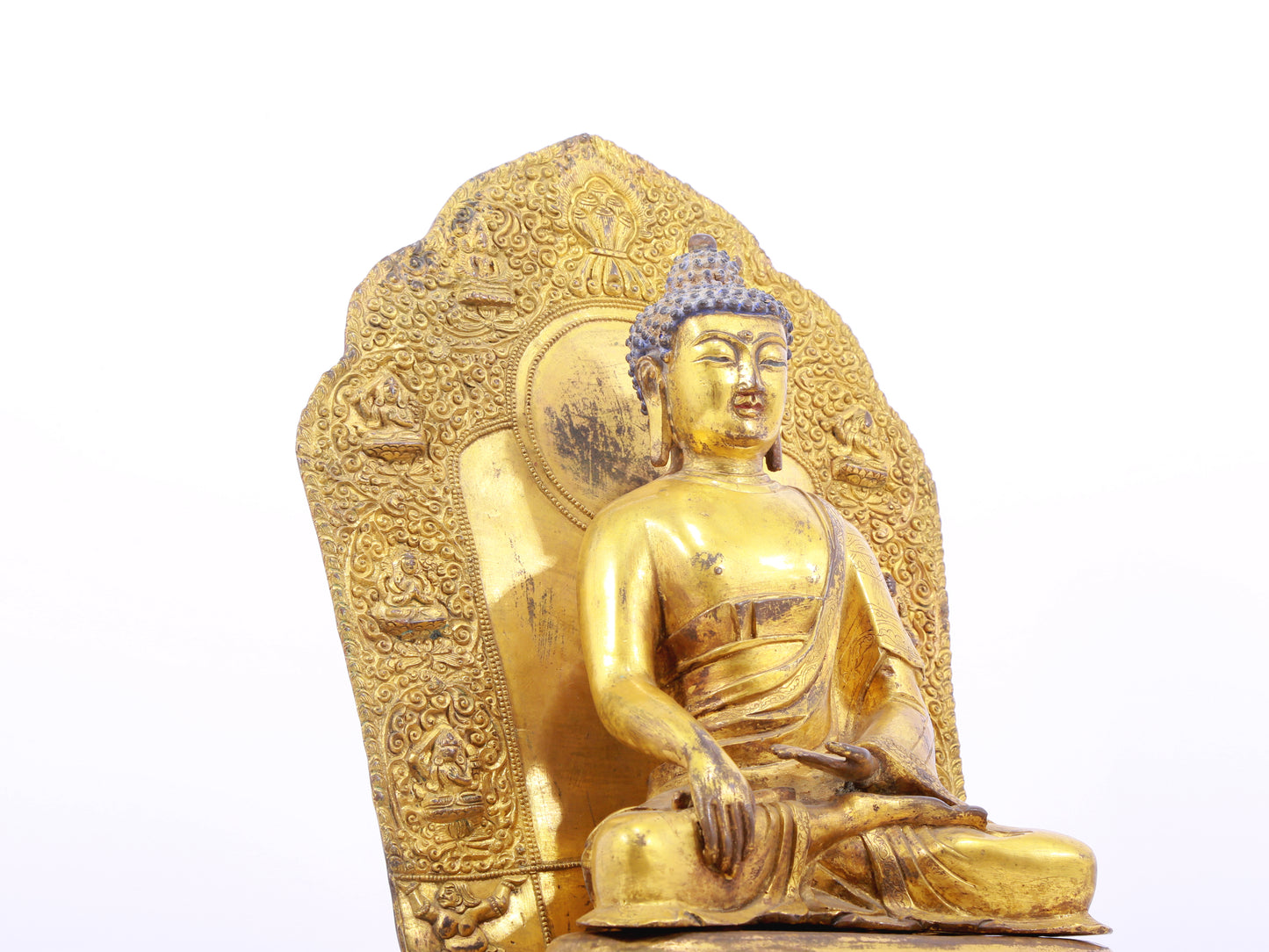 A solemn gilt bronze statue of Gautama Buddha