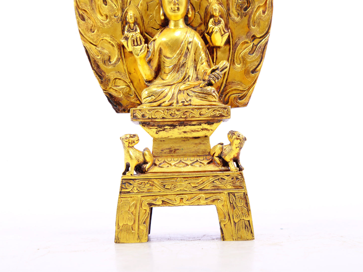 A serene gilt bronze statue of Gautama Buddha