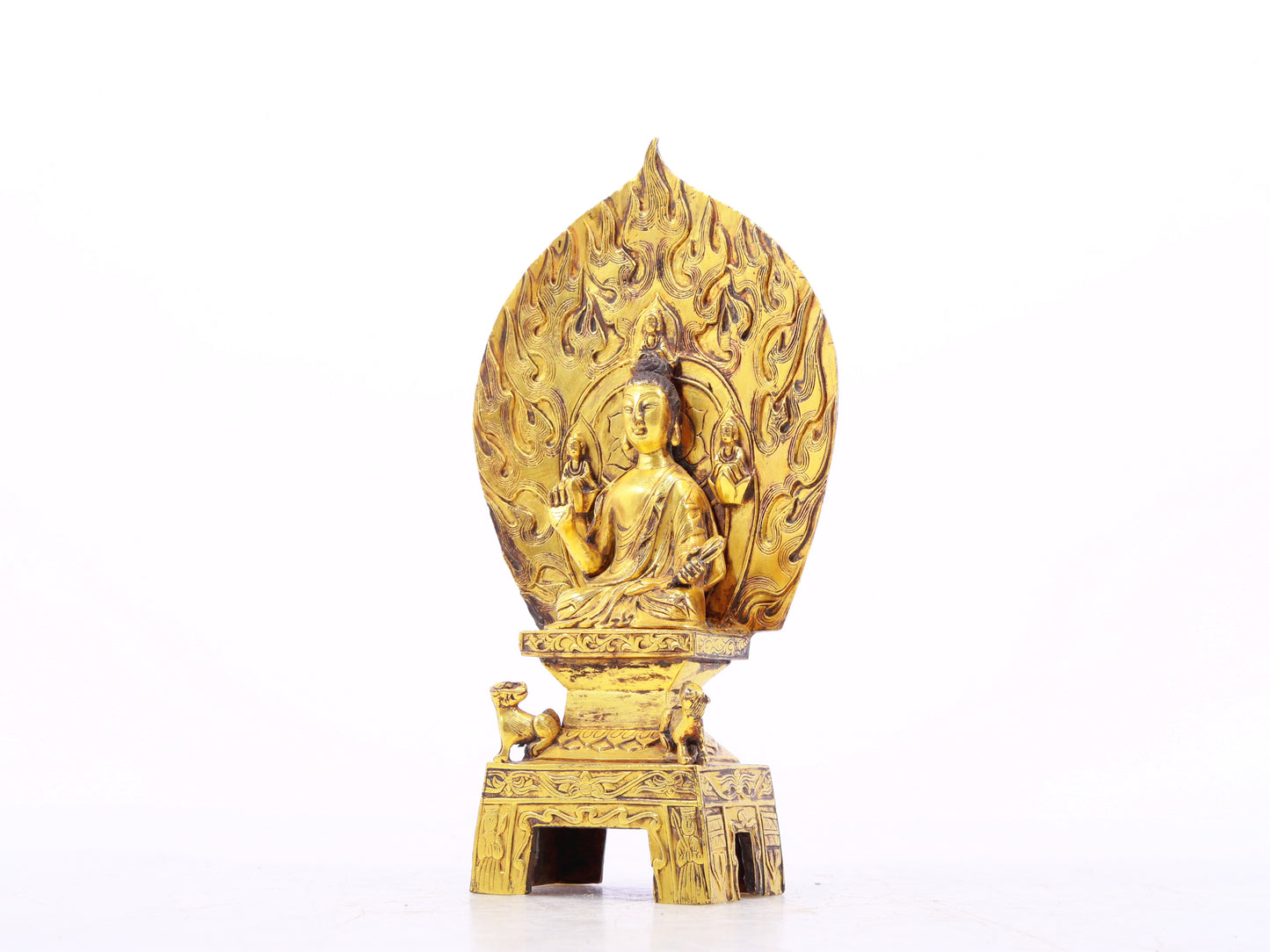 A serene gilt bronze statue of Gautama Buddha