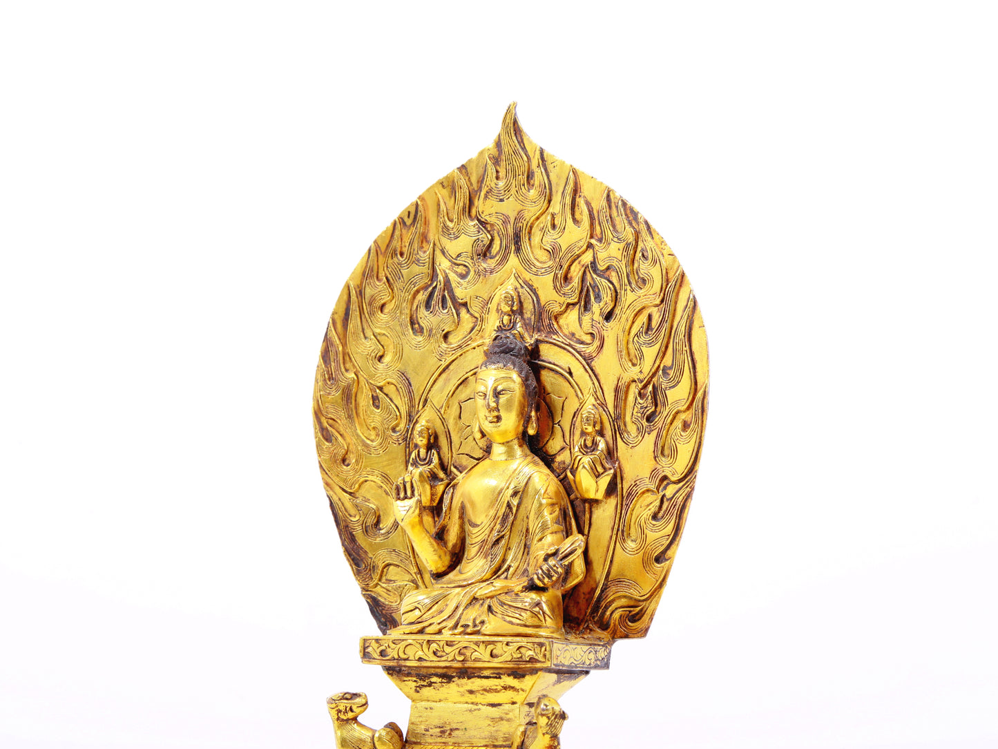 A serene gilt bronze statue of Gautama Buddha