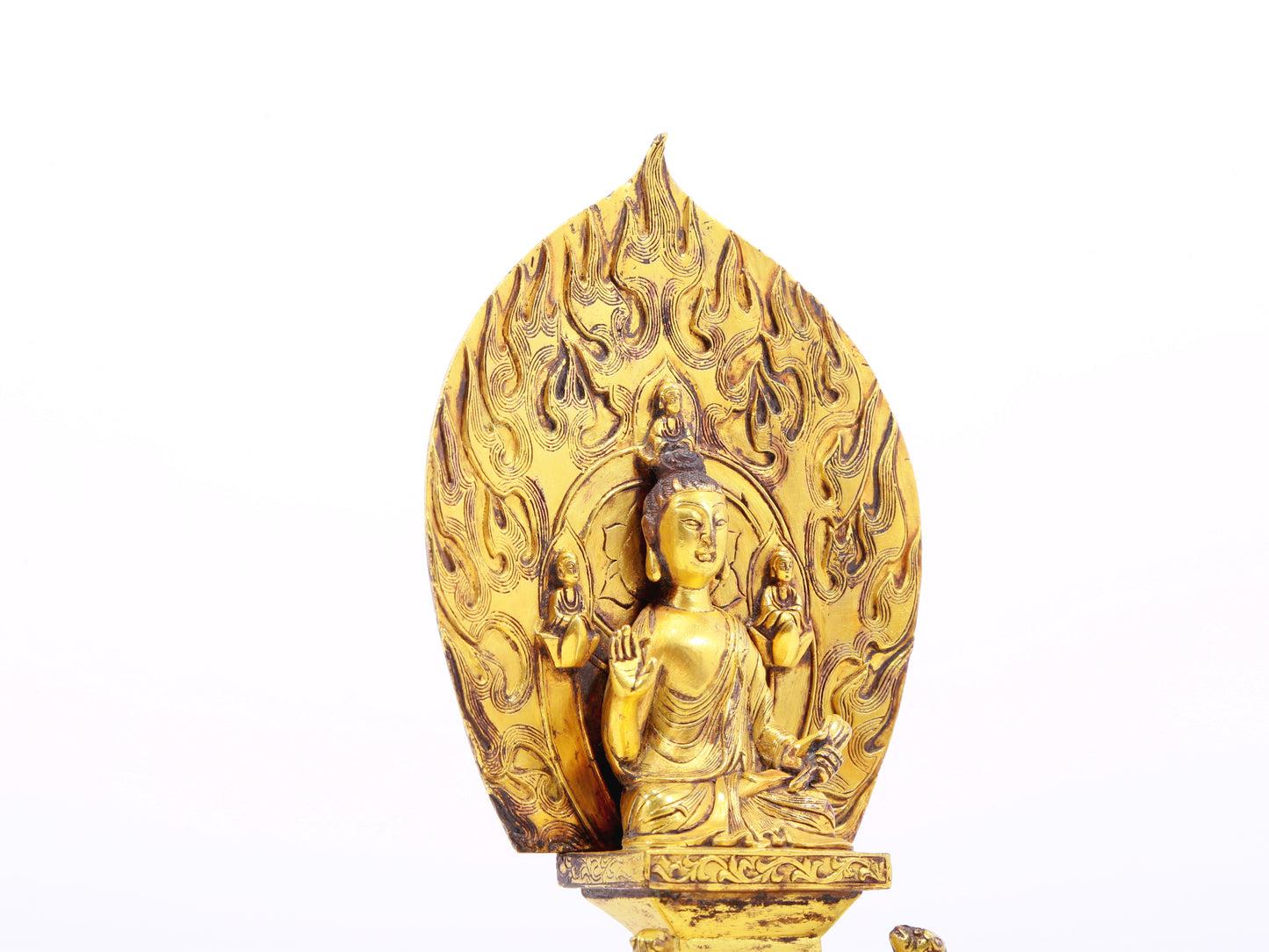 A serene gilt bronze statue of Gautama Buddha