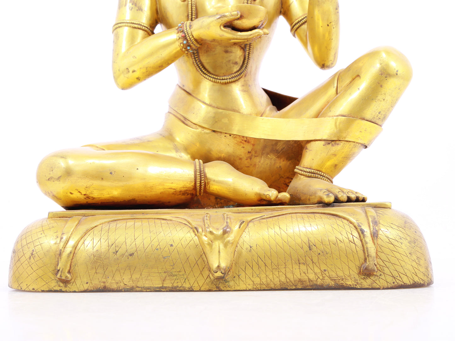 A solemn gilt bronze figure inlaid with turquoise