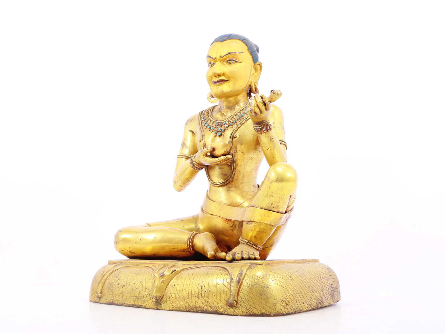 A solemn gilt bronze figure inlaid with turquoise