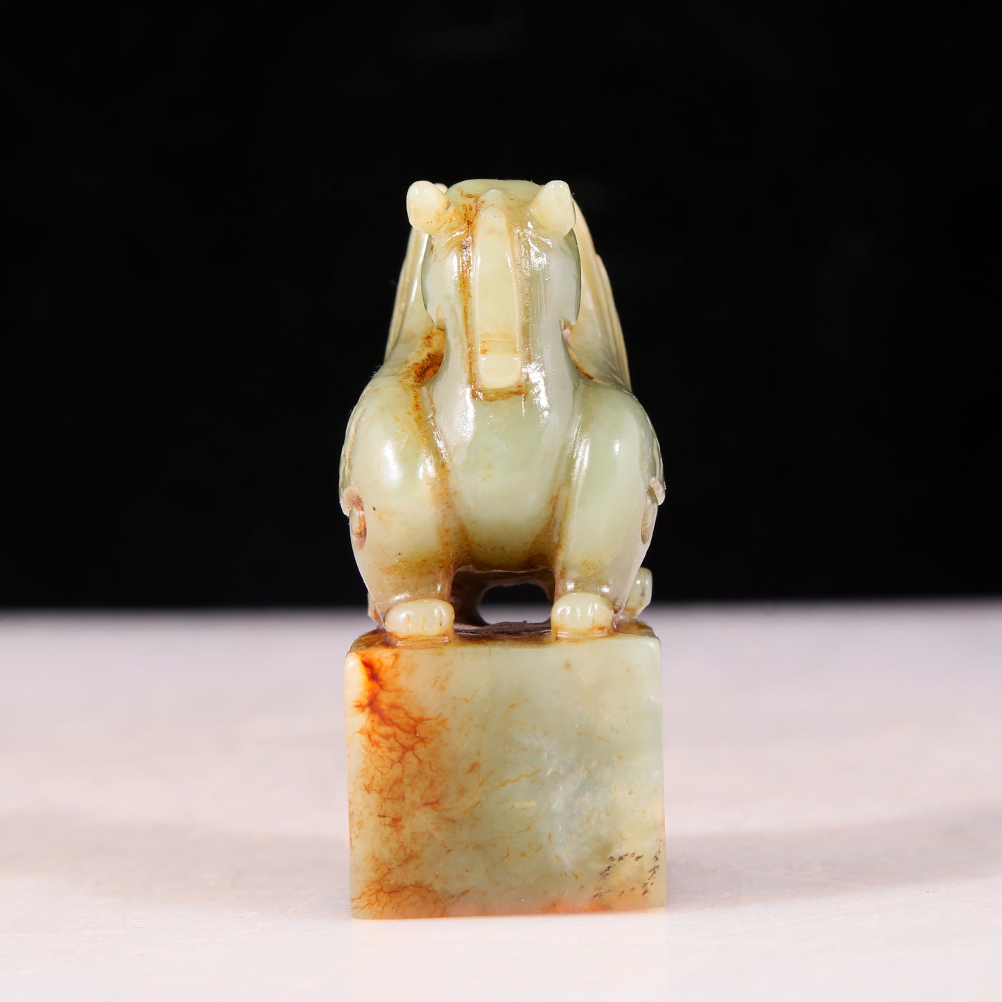 An exquisite green and white jade auspicious animal seal