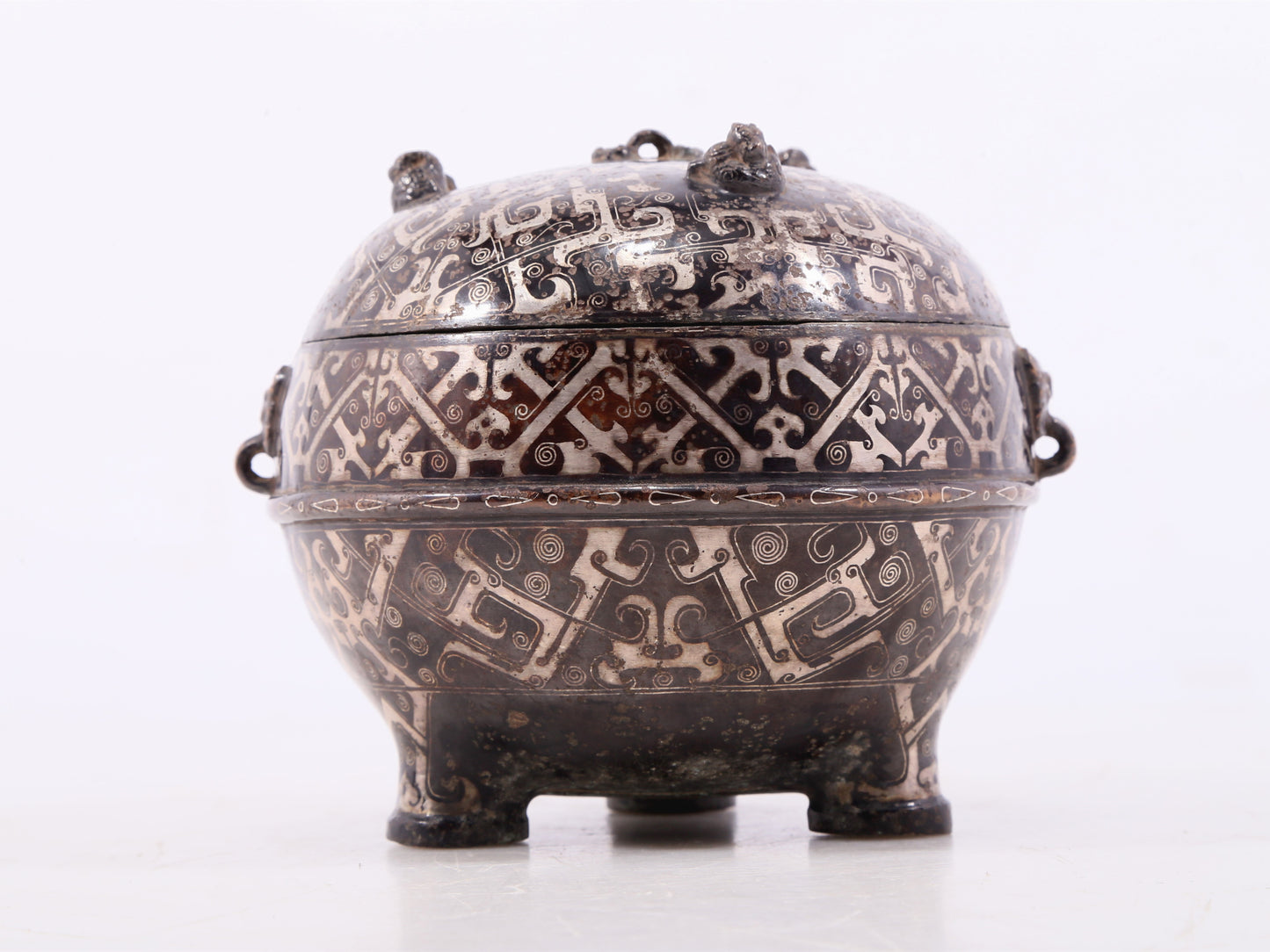 An exquisite bronze-inlaid silver animal-eared tripod jar with lid