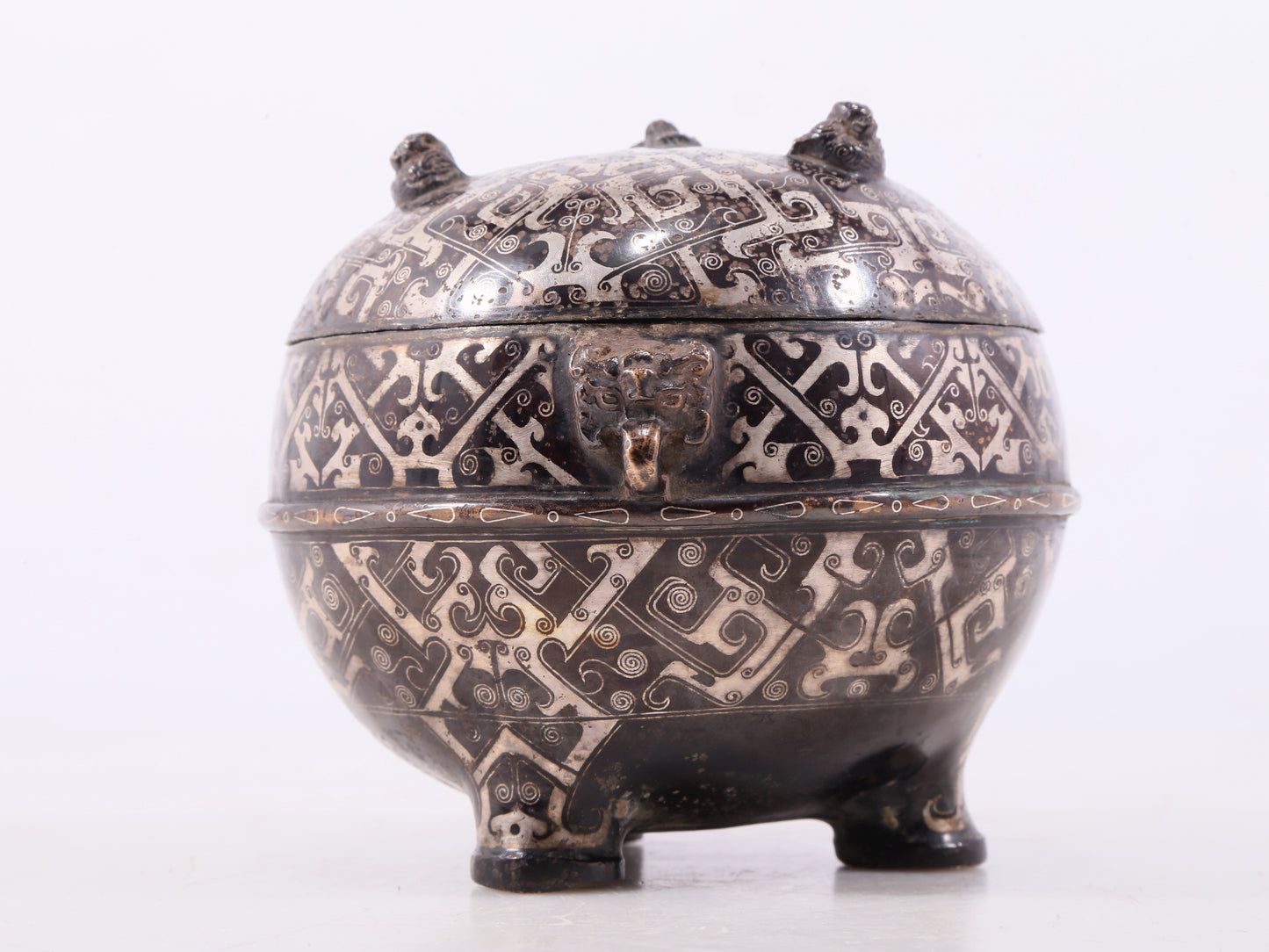 An exquisite bronze-inlaid silver animal-eared tripod jar with lid