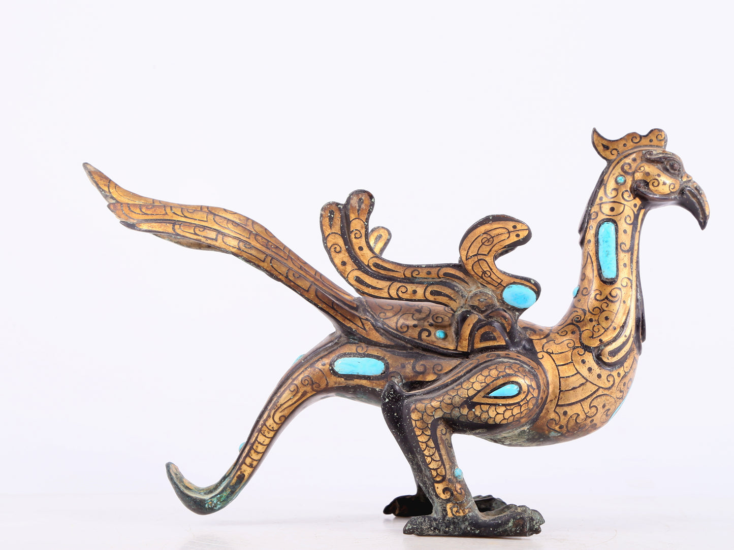 An exquisite bronze inlaid gold and turquoise phoenix ornament