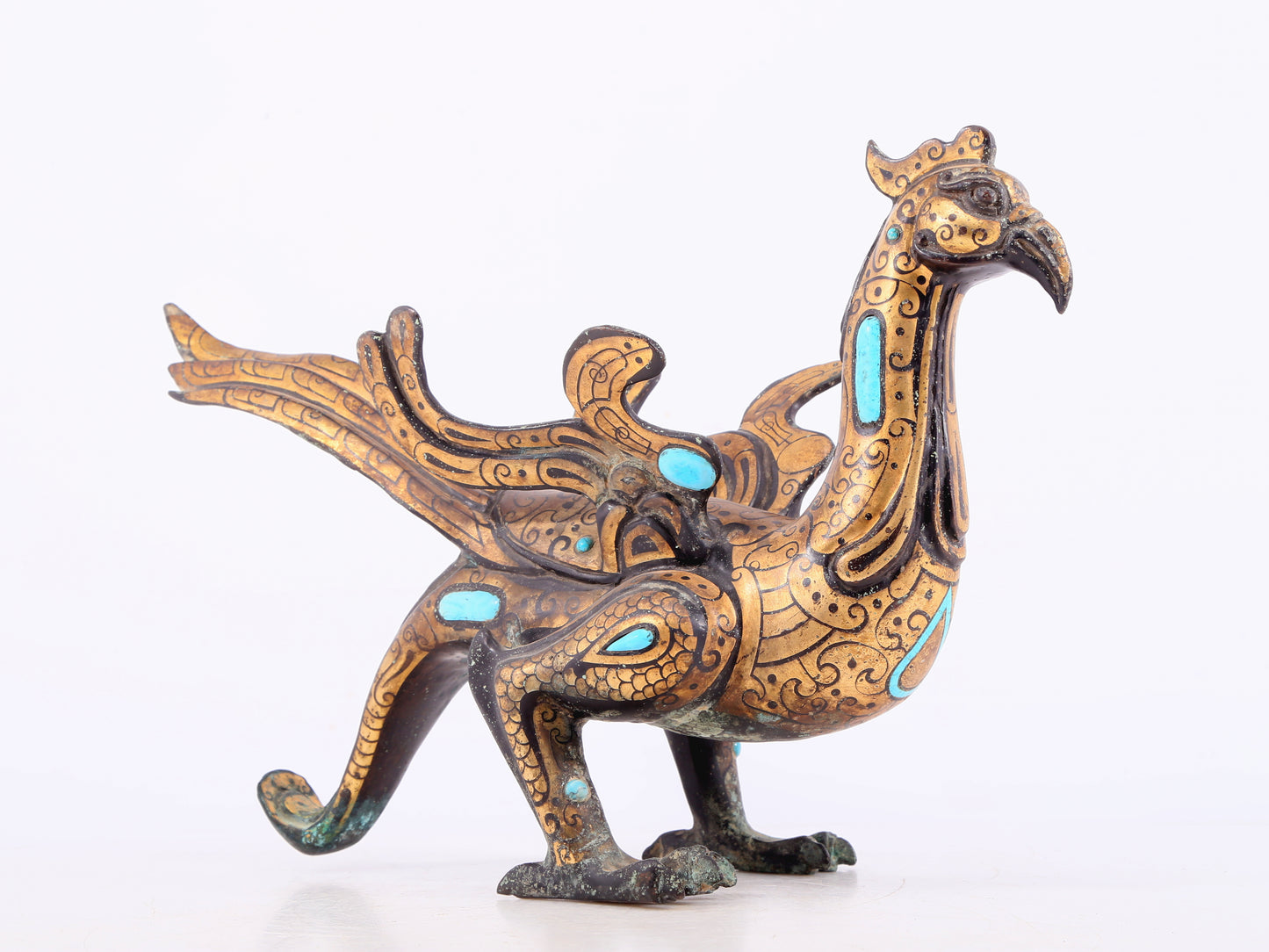 An exquisite bronze inlaid gold and turquoise phoenix ornament