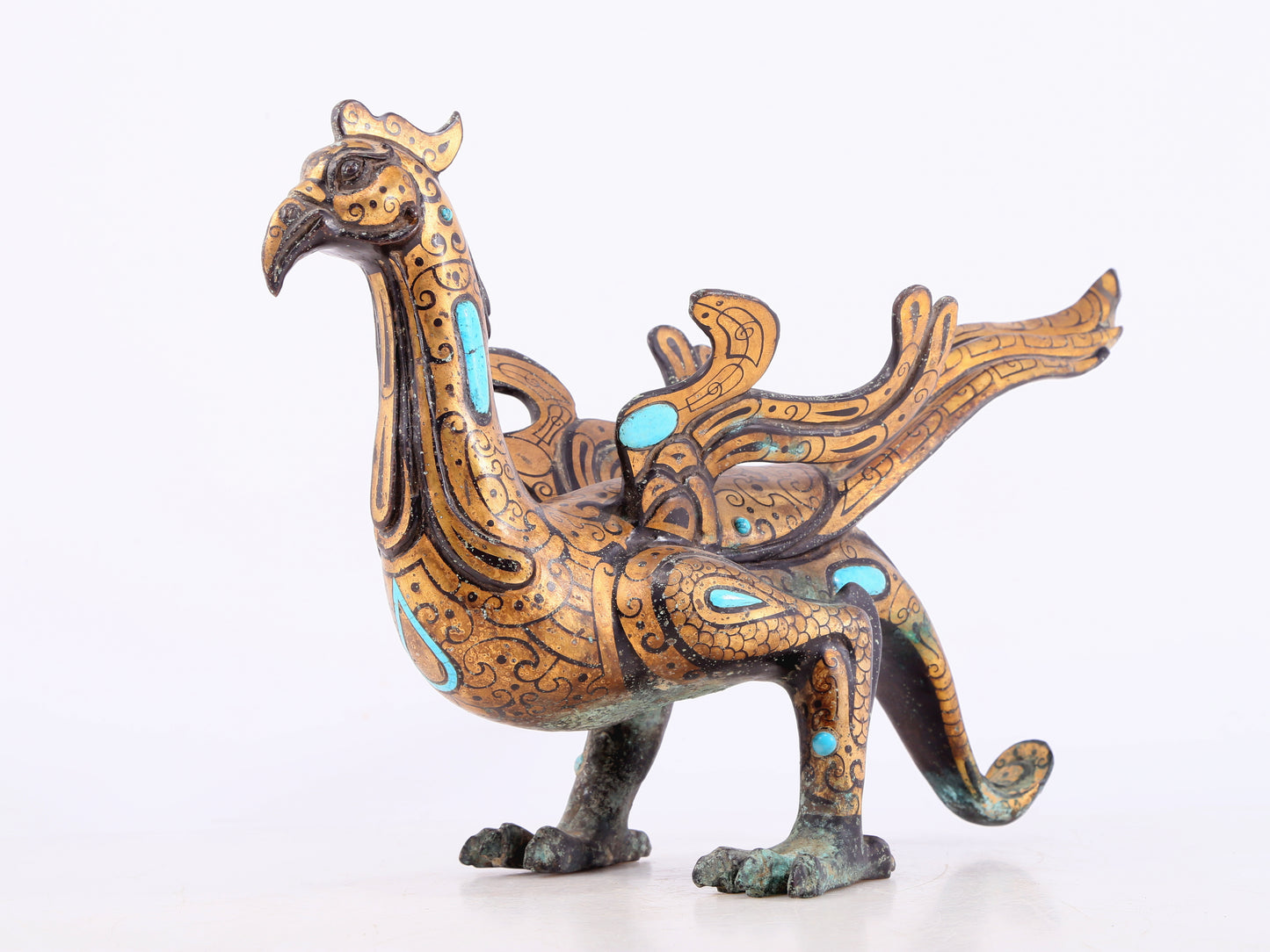 An exquisite bronze inlaid gold and turquoise phoenix ornament