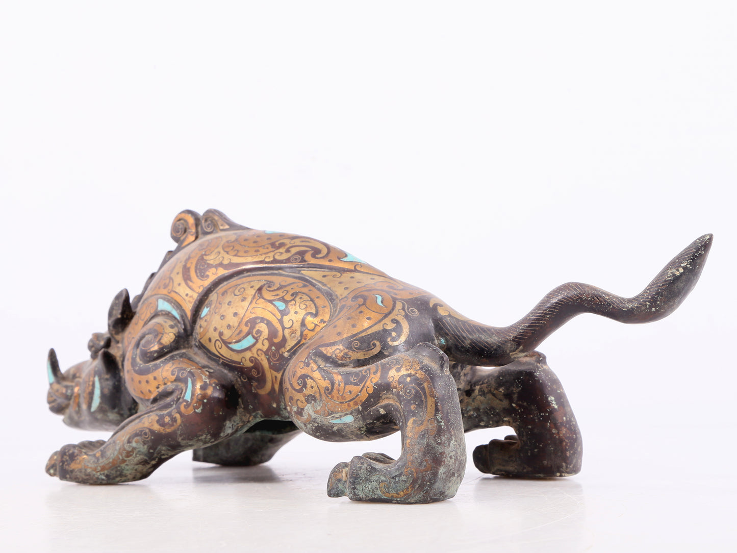 An exquisite bronze inlaid with gold and turquoise auspicious animal ornaments