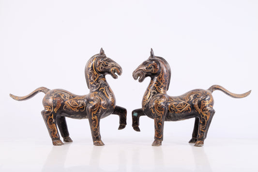 A pair of bronze inlaid gold and silver horse ornaments