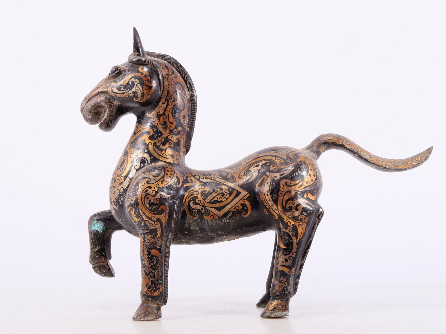 A pair of bronze inlaid gold and silver horse ornaments