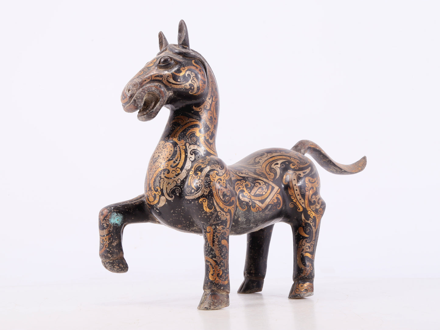 A pair of bronze inlaid gold and silver horse ornaments