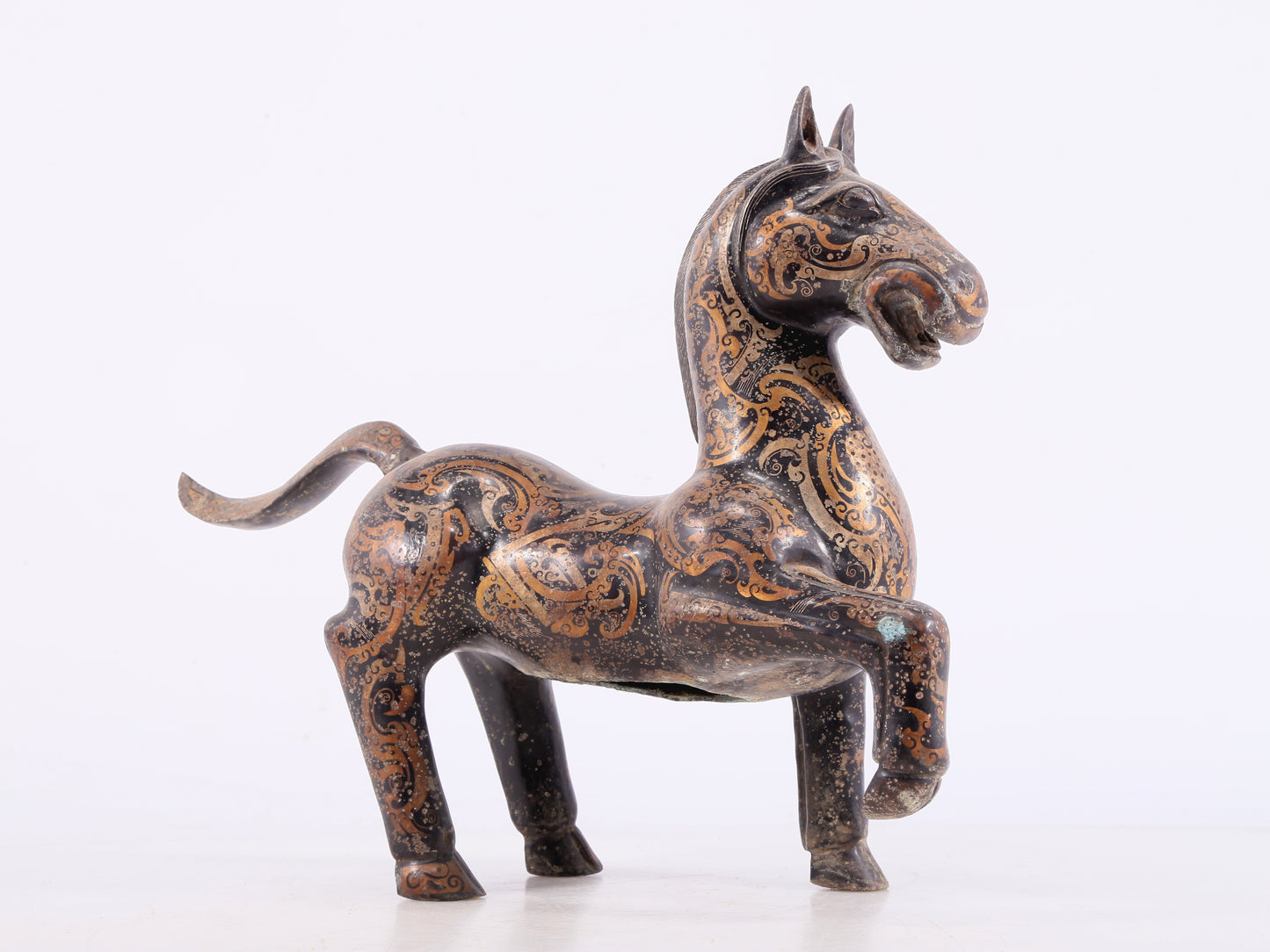 A pair of bronze inlaid gold and silver horse ornaments