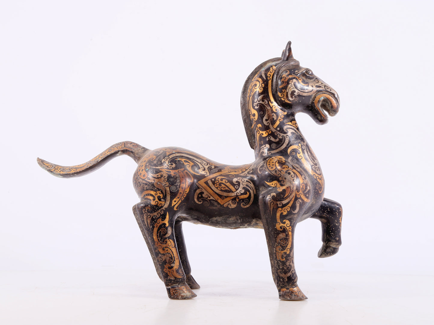 A pair of bronze inlaid gold and silver horse ornaments