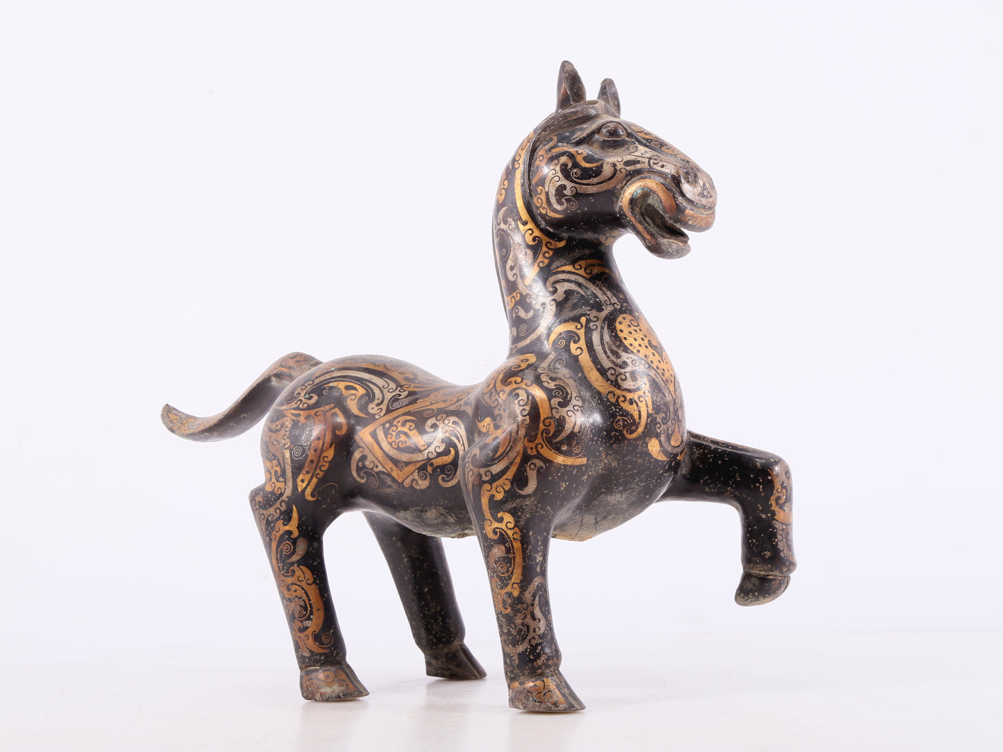 A pair of bronze inlaid gold and silver horse ornaments