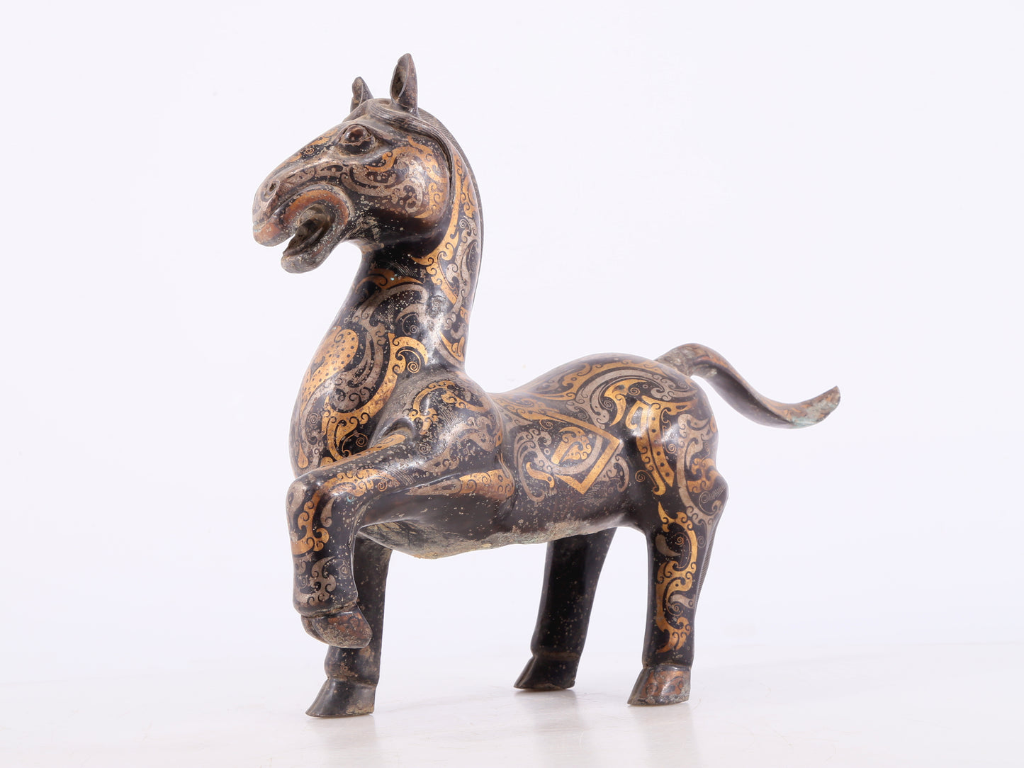 A pair of bronze inlaid gold and silver horse ornaments