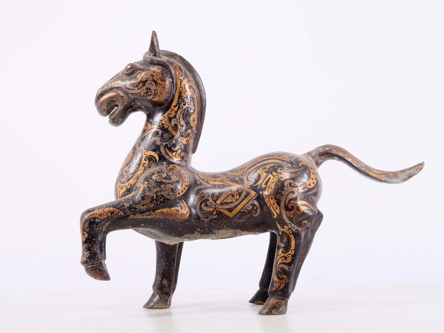 A pair of bronze inlaid gold and silver horse ornaments