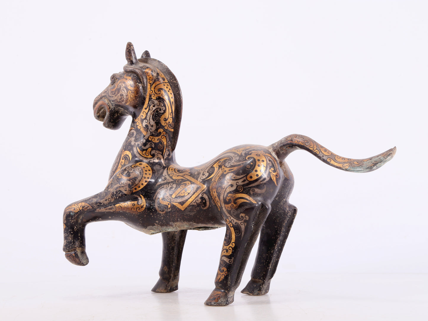 A pair of bronze inlaid gold and silver horse ornaments