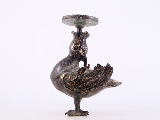 An exquisite bronze inlaid gold and silver candlestick with auspicious animals