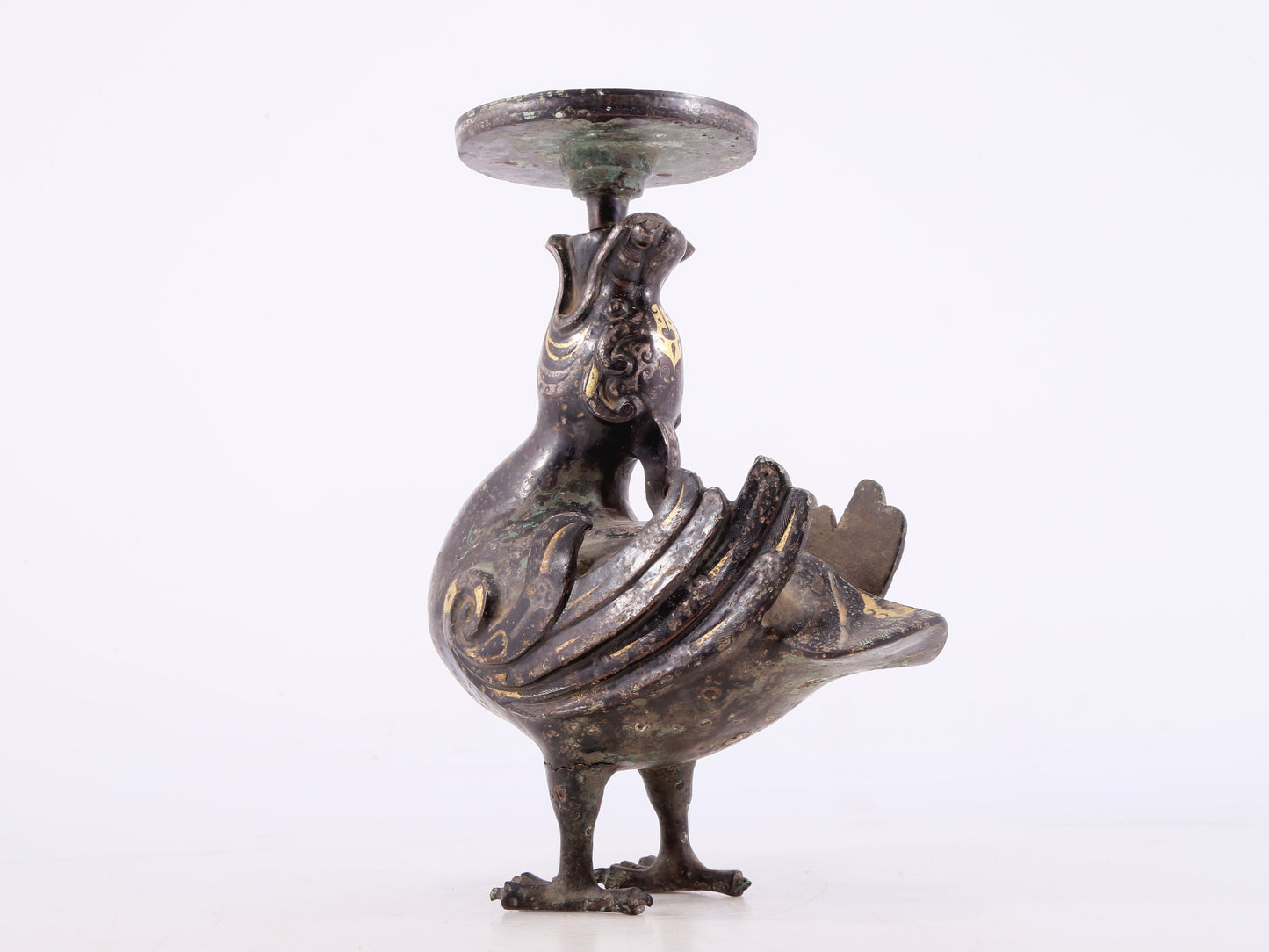 An exquisite bronze inlaid gold and silver candlestick with auspicious animals