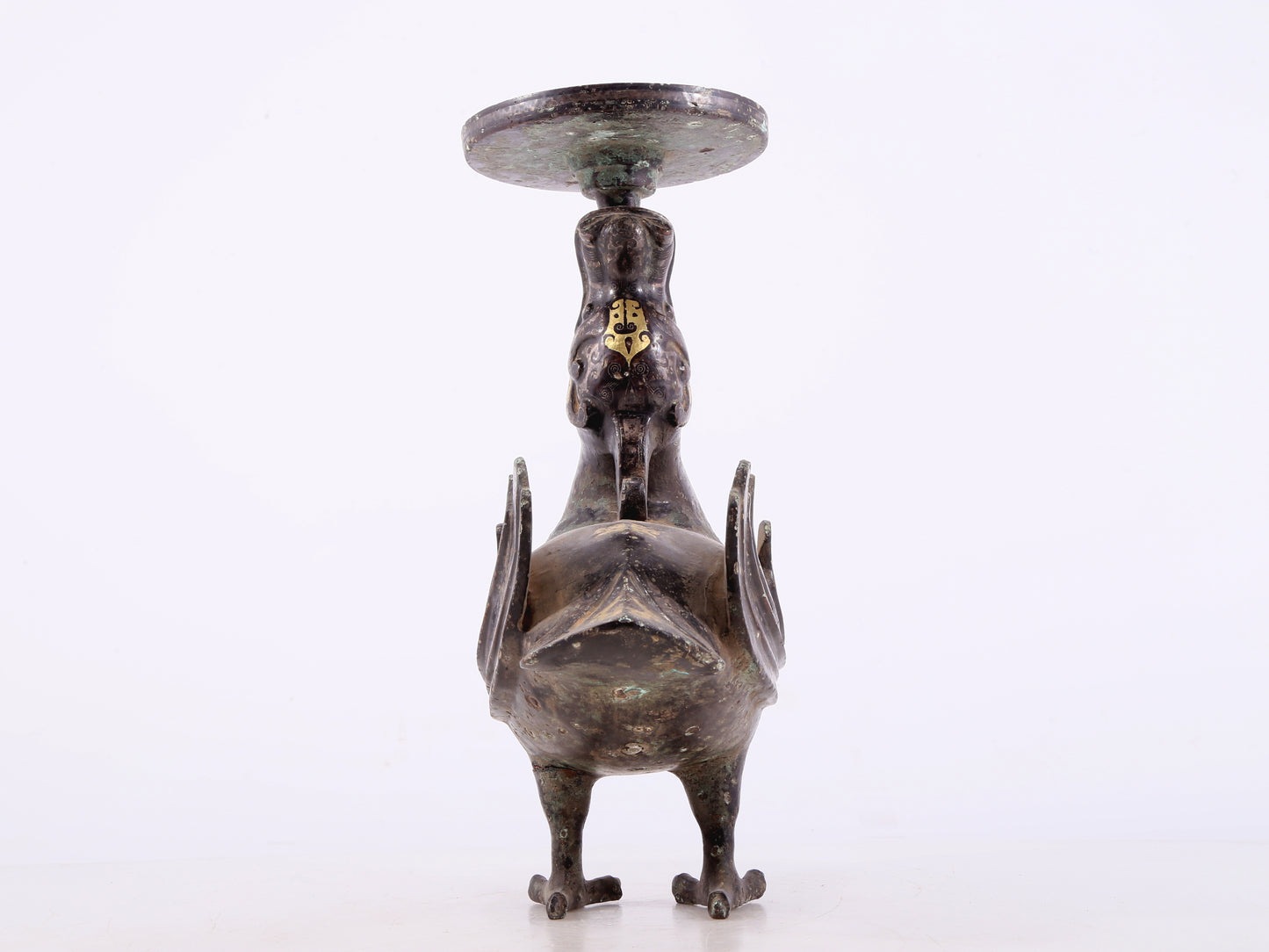 An exquisite bronze inlaid gold and silver candlestick with auspicious animals