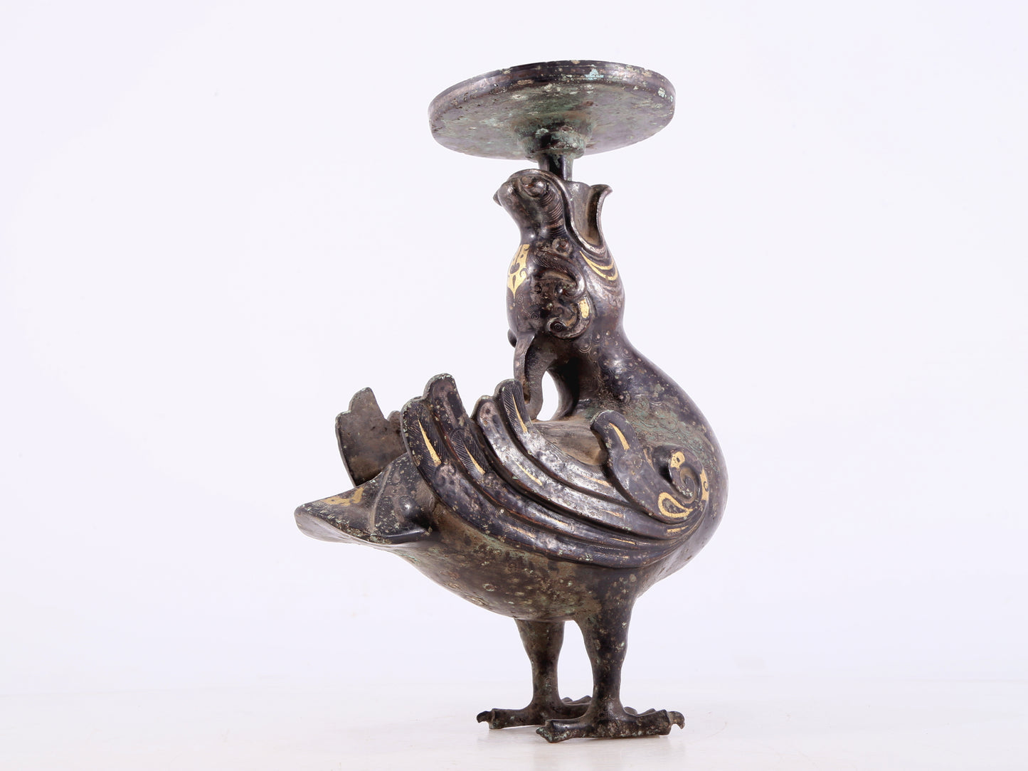 An exquisite bronze inlaid gold and silver candlestick with auspicious animals