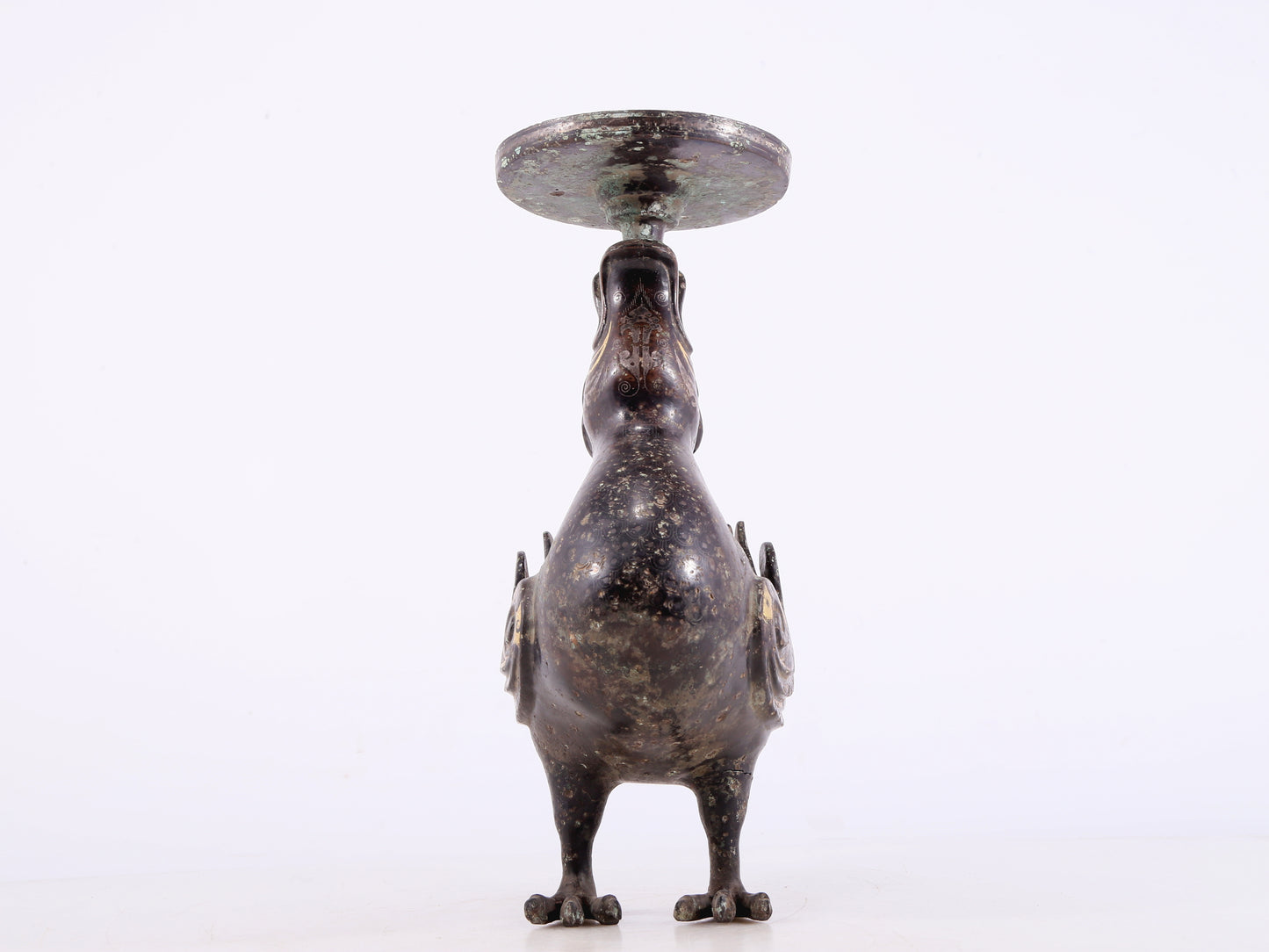 An exquisite bronze inlaid gold and silver candlestick with auspicious animals