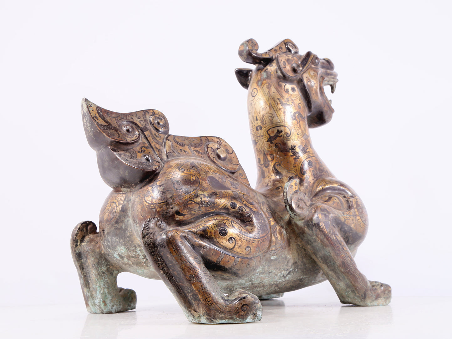 An exquisite bronze inlaid gold and silver auspicious animal ornament