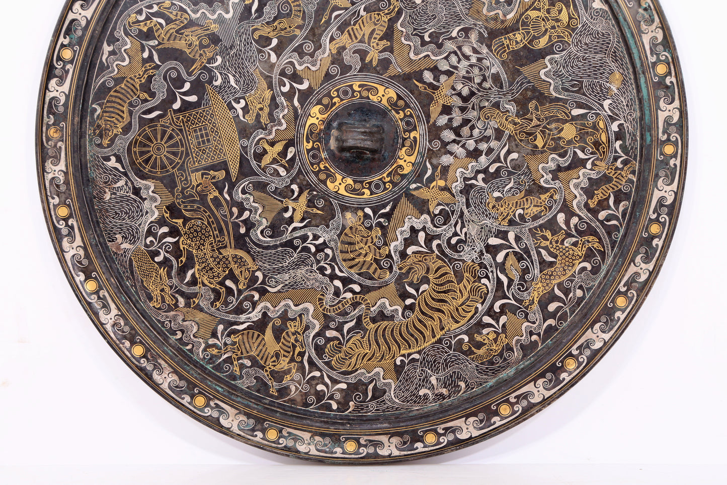 An exquisite bronze inlaid gold and silver mirror with auspicious animal patterns