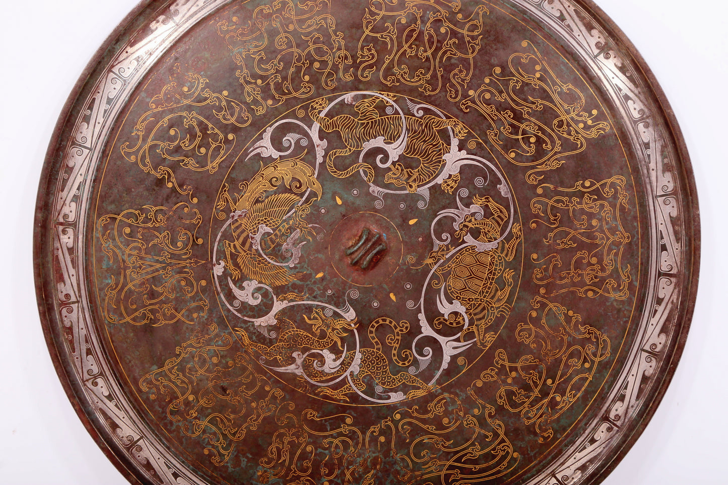 An exquisite bronze inlaid gold and silver round mirror with auspicious animal patterns