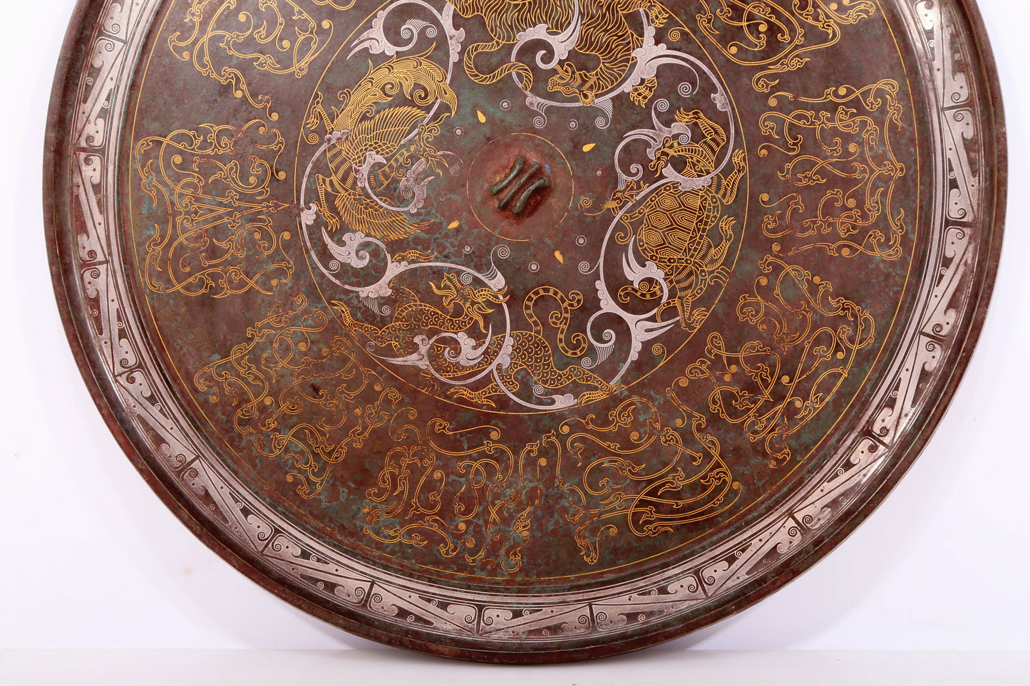 An exquisite bronze inlaid gold and silver round mirror with auspicious animal patterns