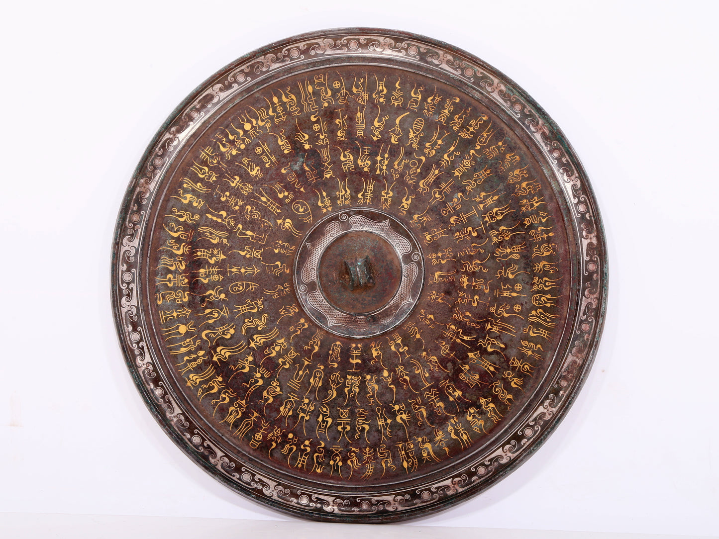 An exquisite bronze inlaid gold and silver Ruyi pattern round mirror