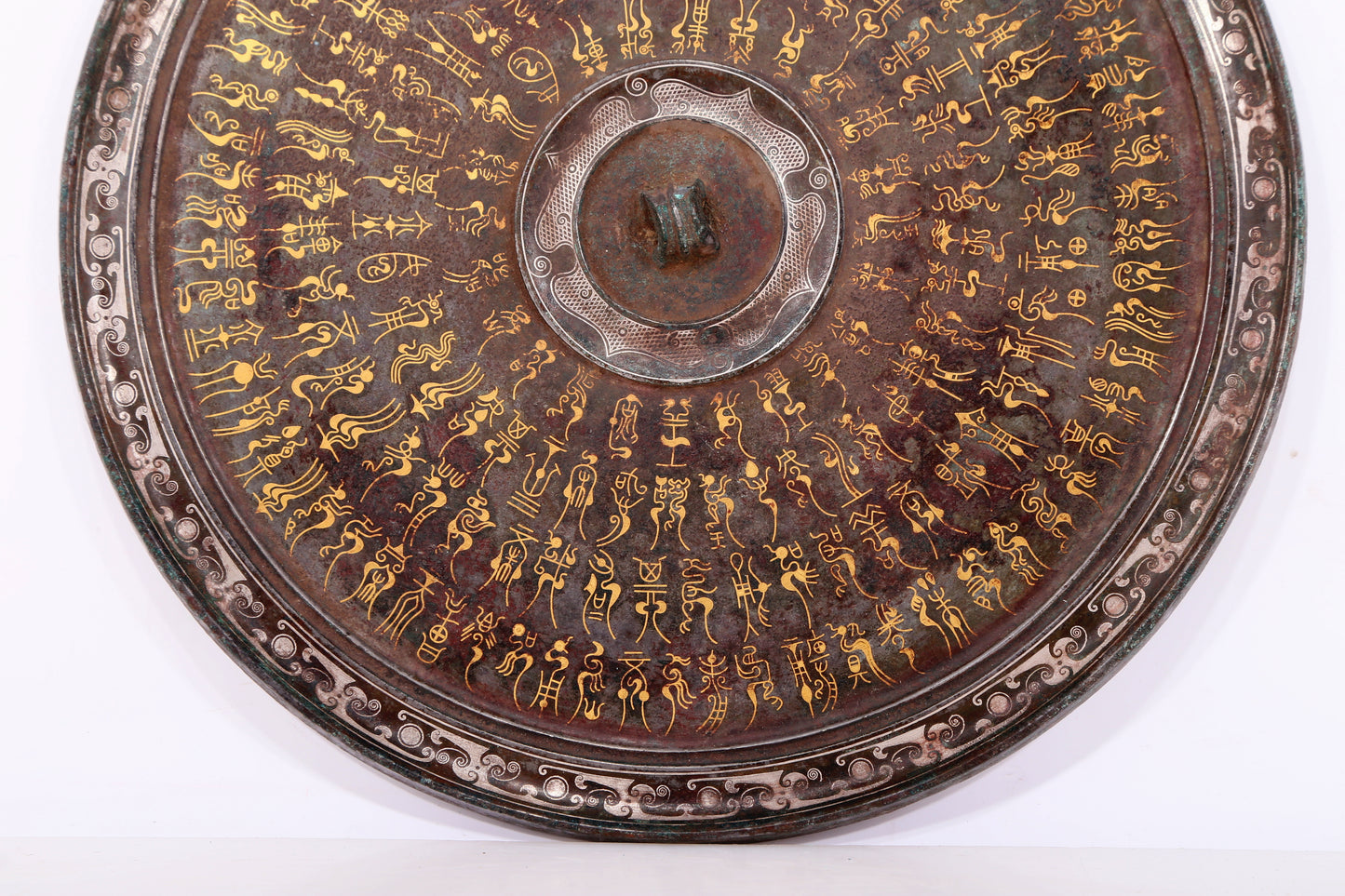 An exquisite bronze inlaid gold and silver Ruyi pattern round mirror