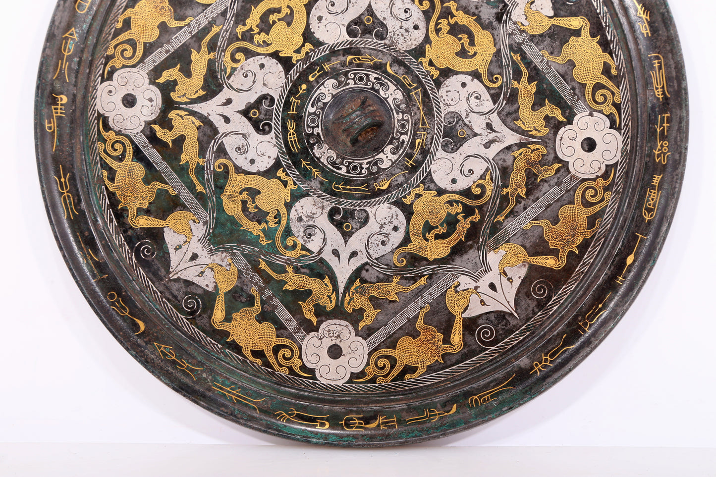 An exquisite bronze inlaid gold and silver round mirror with auspicious animal patterns