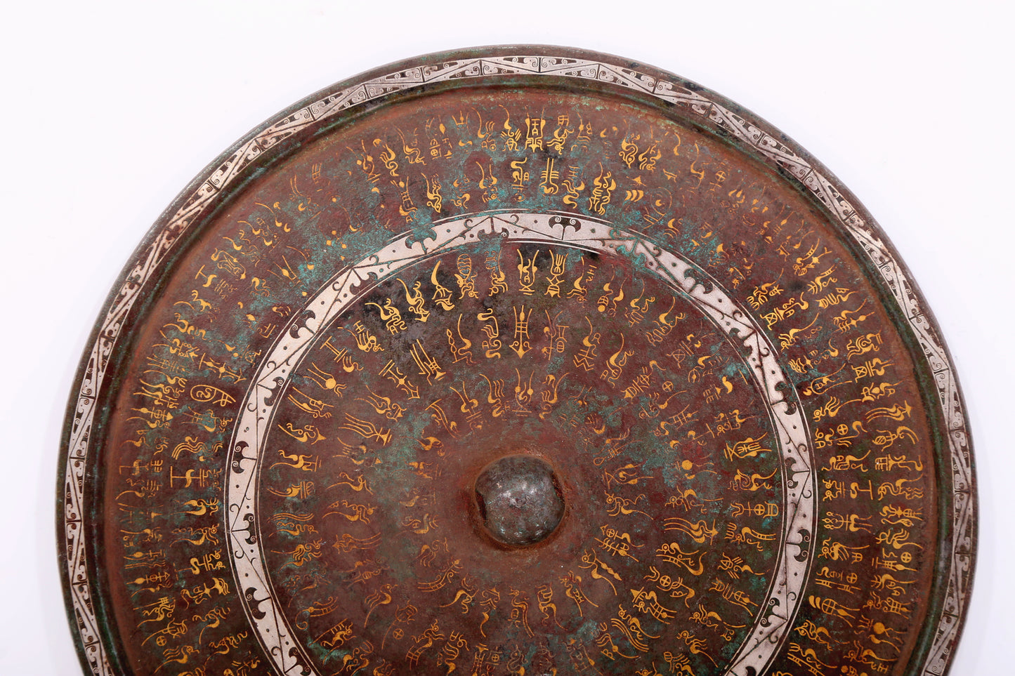 An exquisite bronze inlaid gold and silver Ruyi pattern round mirror