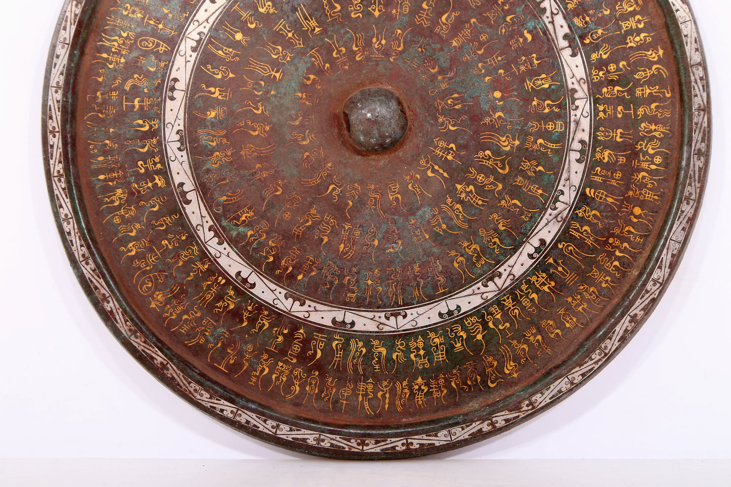 An exquisite bronze inlaid gold and silver Ruyi pattern round mirror