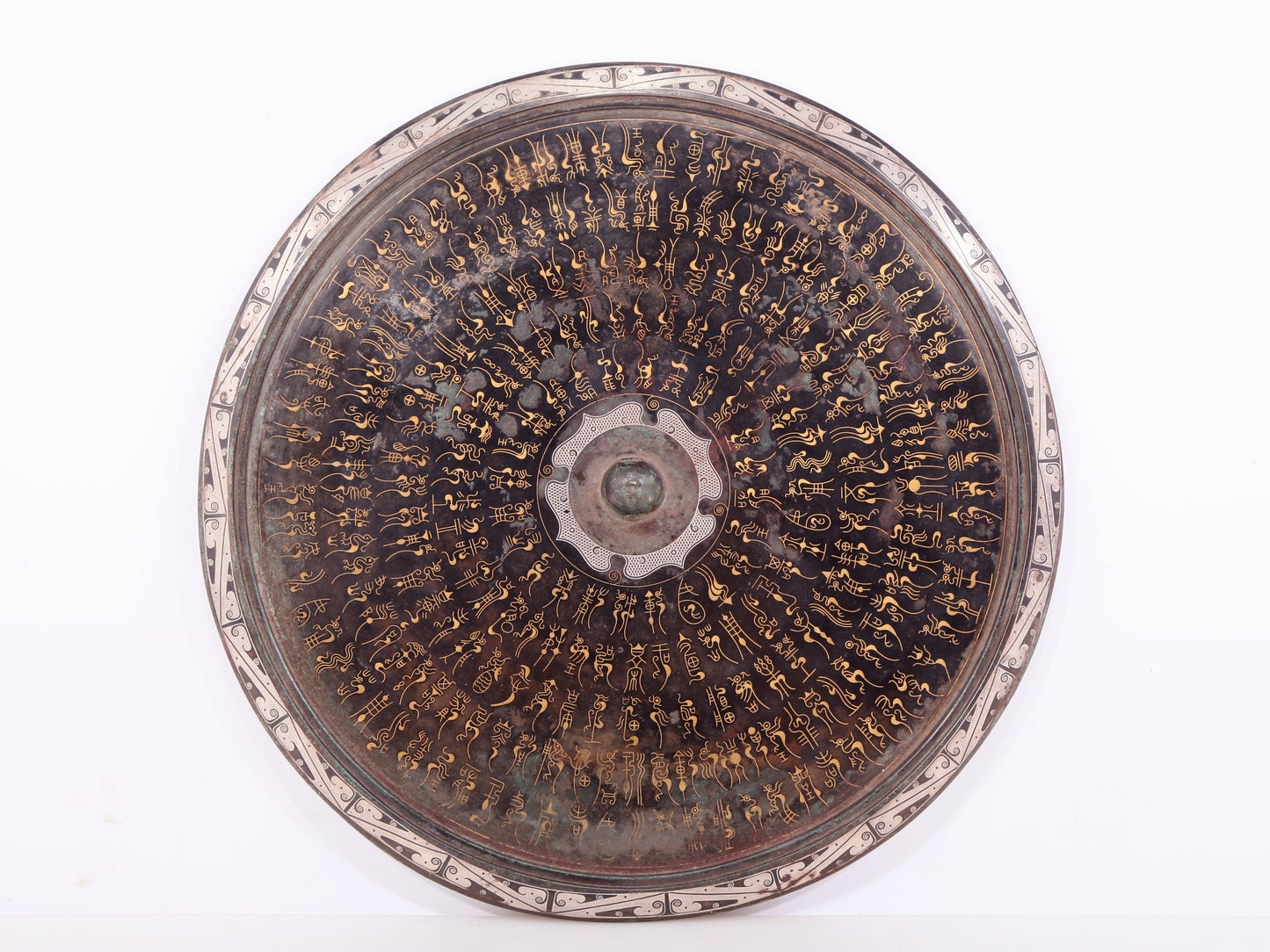 An exquisite bronze inlaid gold and silver Ruyi pattern round mirror