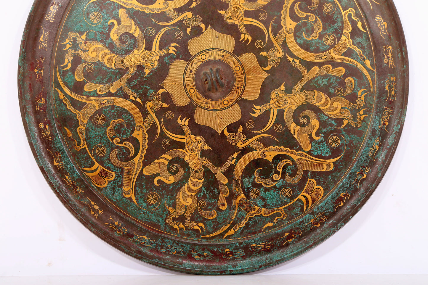 An exquisite bronze inlaid gold and silver round mirror with auspicious animal patterns