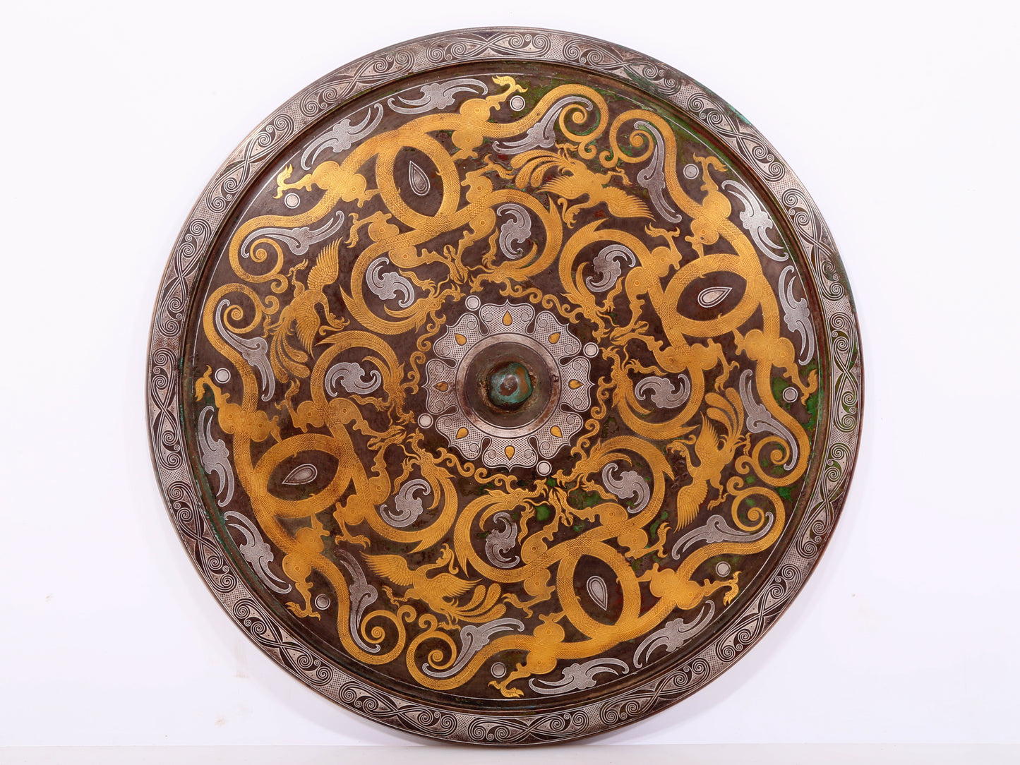 An exquisite bronze inlaid gold and silver dragon and phoenix pattern round mirror