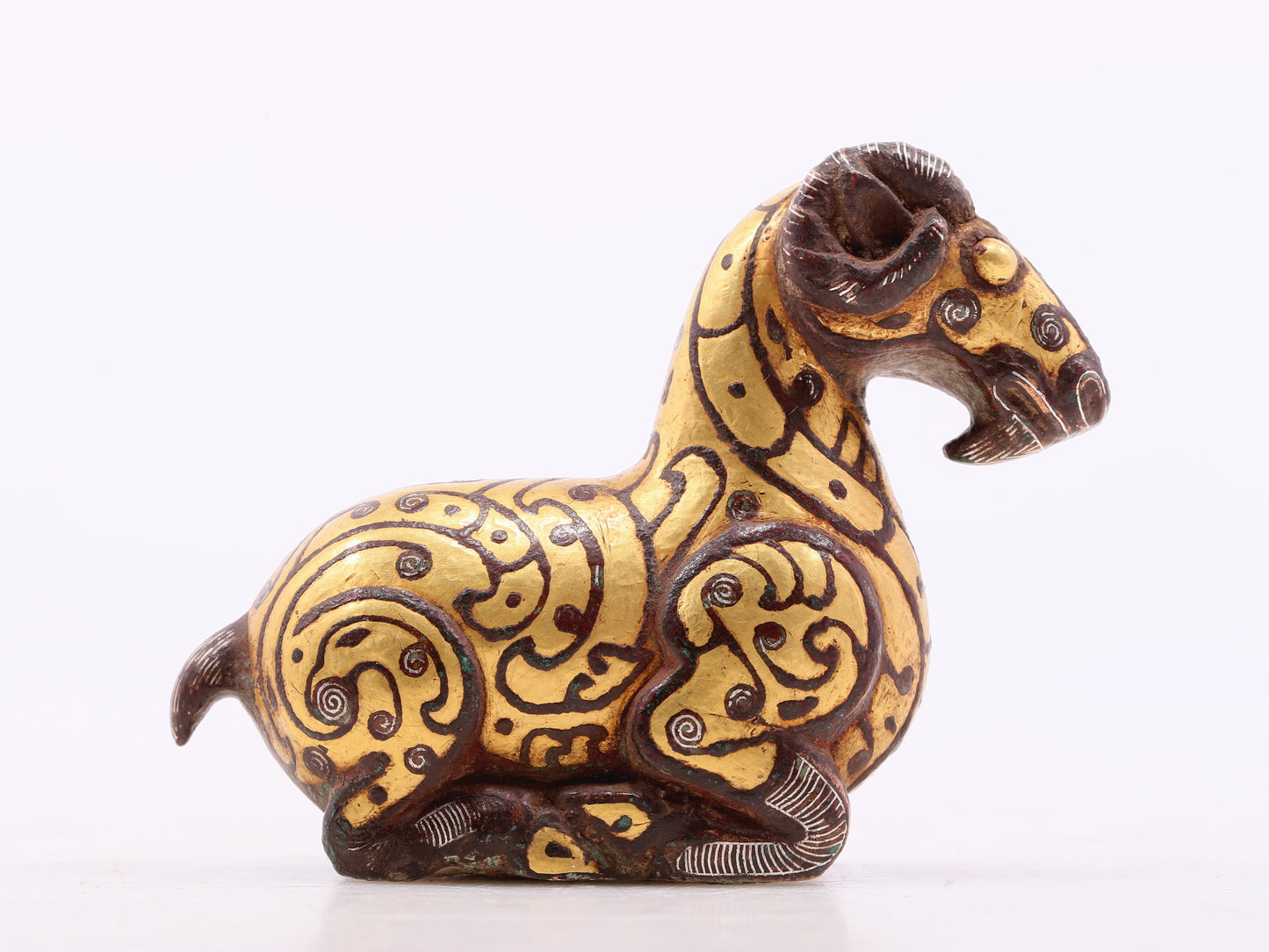 A pair of bronze inlaid gold and silver goat ornaments